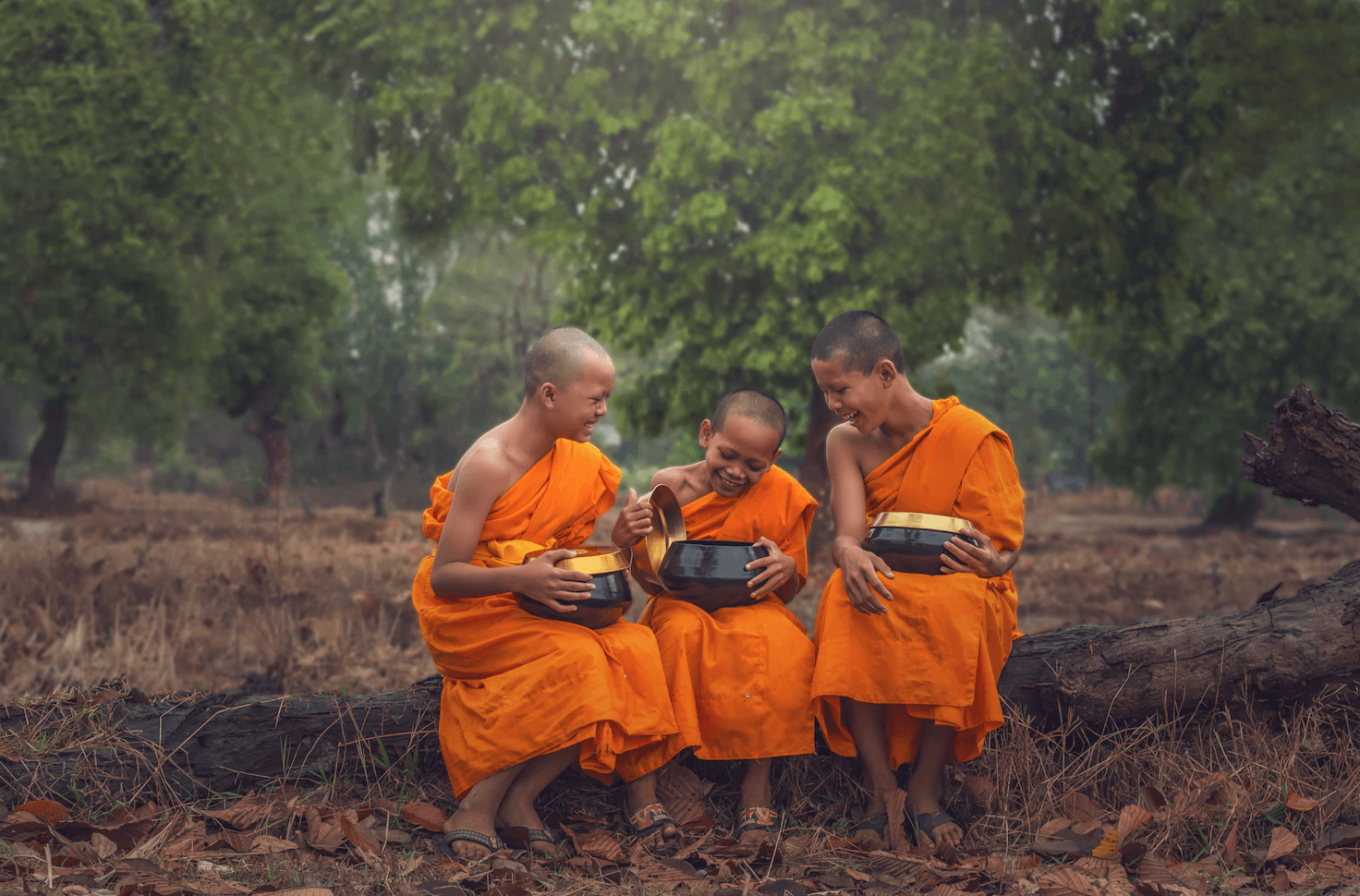 A photo from the 'authentic' collection, curated by our photo & video review teams. This photo depicts three young monks sitting on a log.