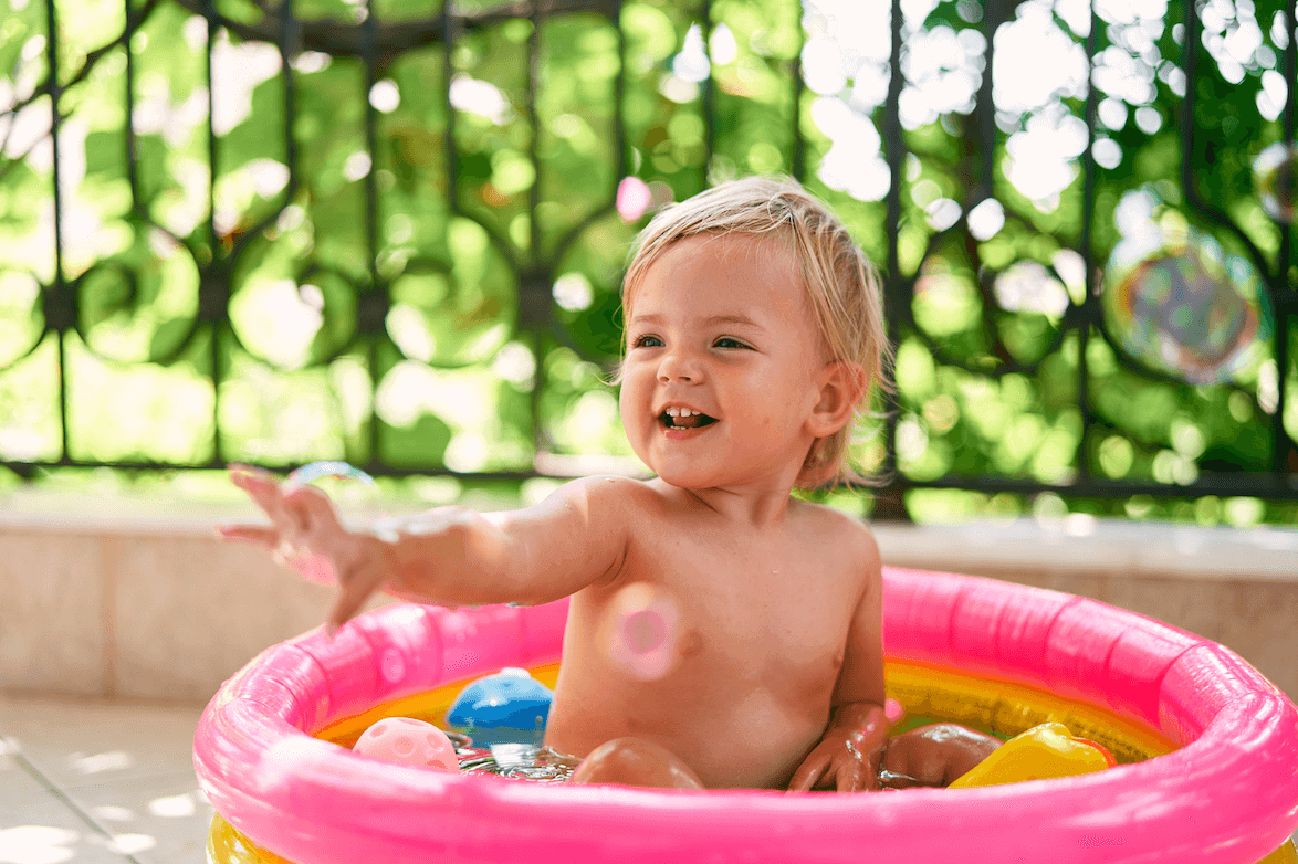A photo from the 'summer vibes' collection, curated by our photo & video review teams. This photo depicts a toddler in a pink ball pit.