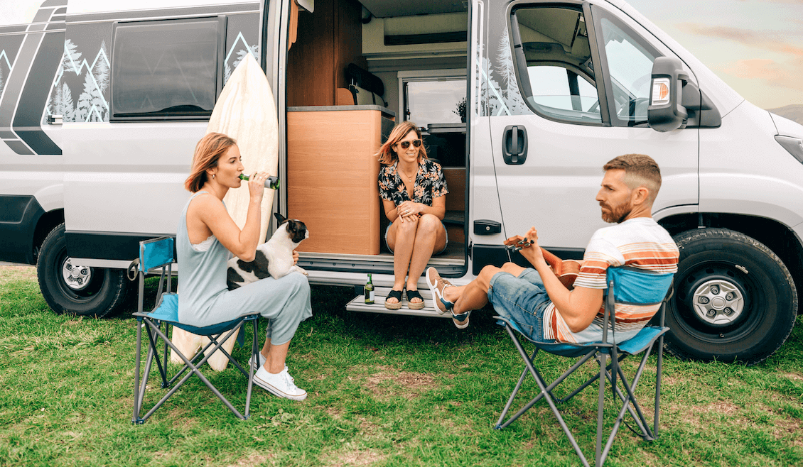 A photo from the 'summer vibes' collection, curated by our photo & video review teams. This photo depicts a group of people sitting outside a van.